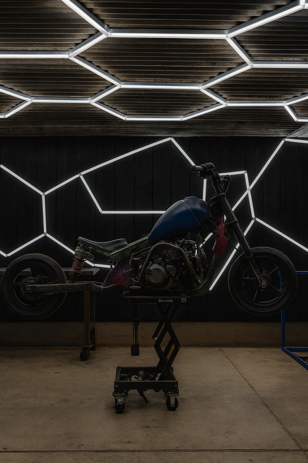 Vanta blue custom street mini bike on hydraulic lift with LED hexagon background